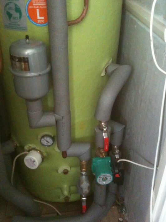 Gravity-fed wood-burning heating system